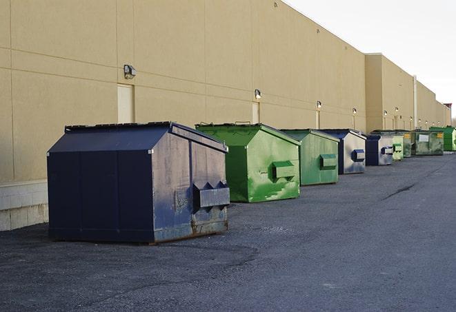 a row of yellow and blue dumpsters at a construction site in Cranford NJ